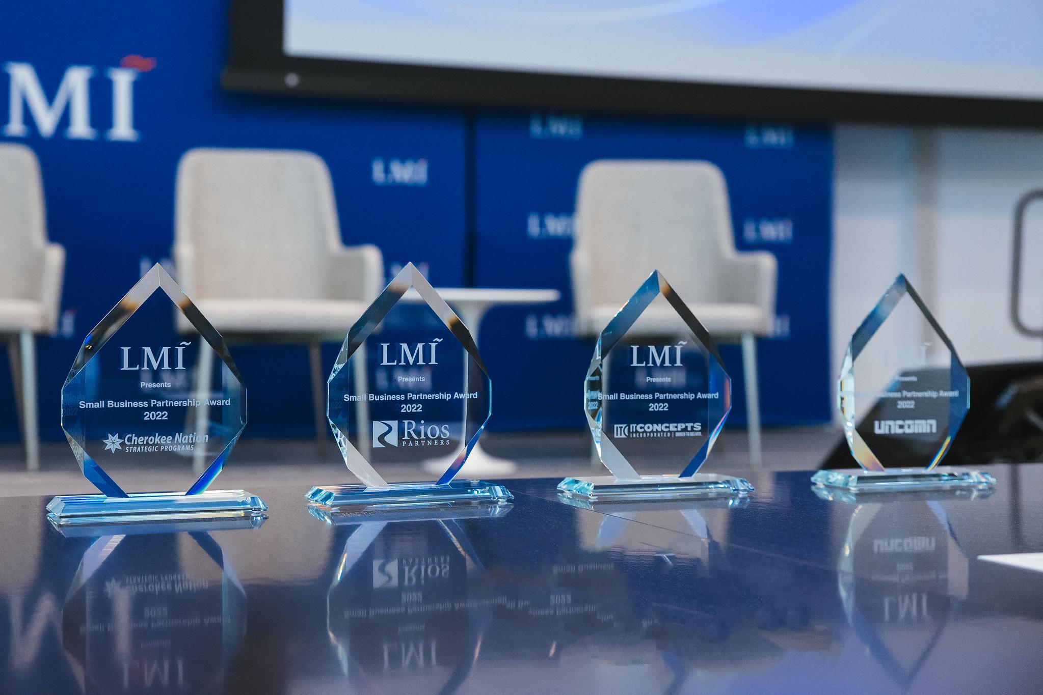four small business award plaques on a table